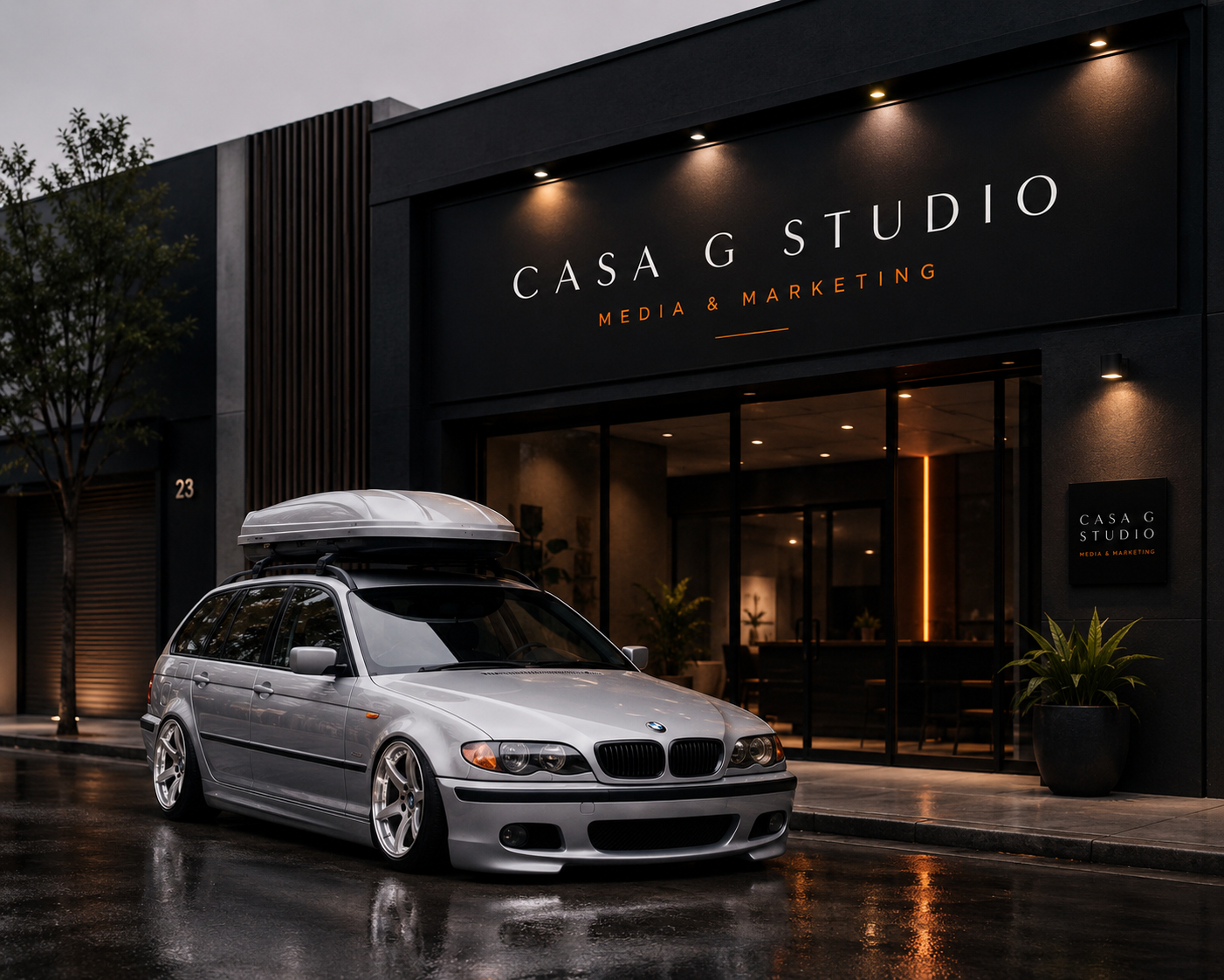 Silver BMW E46 wagon parked in front of the Casa G Studio building